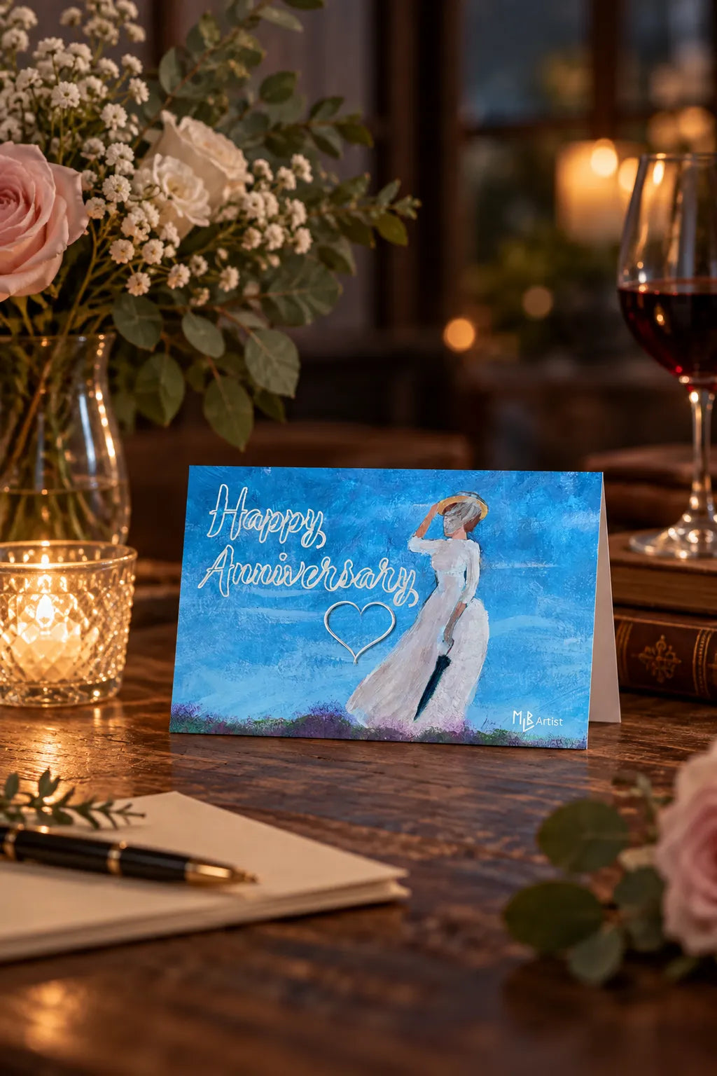 Anniversary card beside flowers and a thoughtful gift